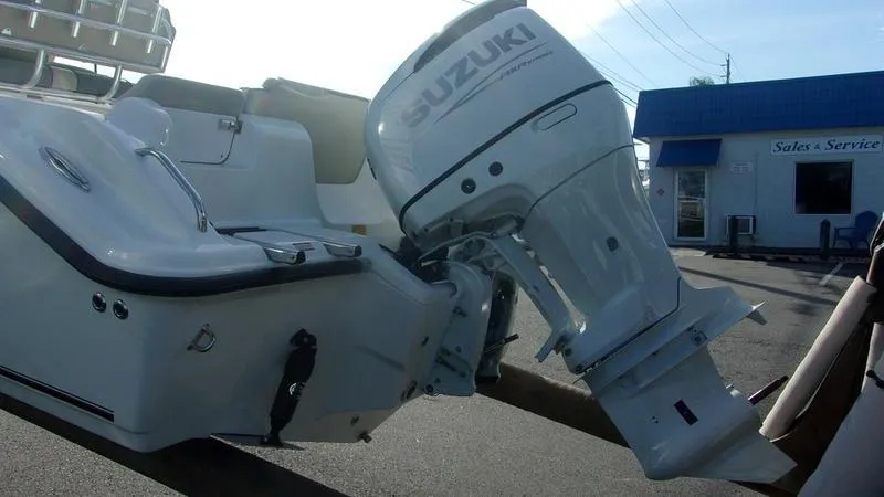 Slide: The Image of 2025 Key West 239 FS boat with Suzuki outboard motor at dealership. - 4