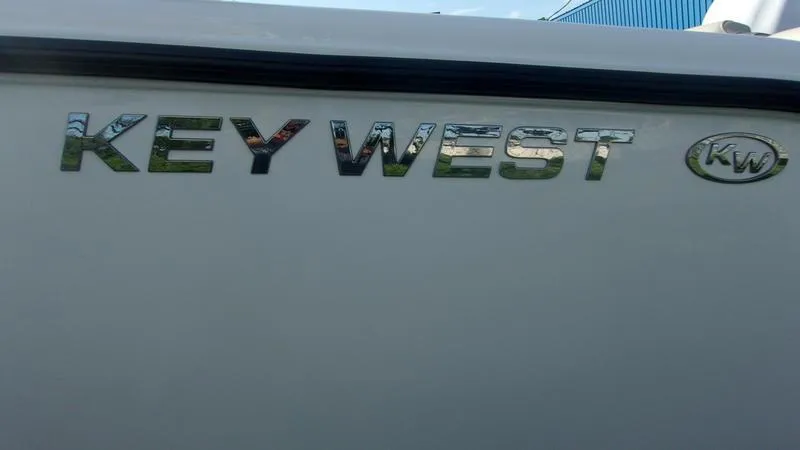 Slide: The Image of Key West 239 FS 2025 boat logo on white surface. - 5