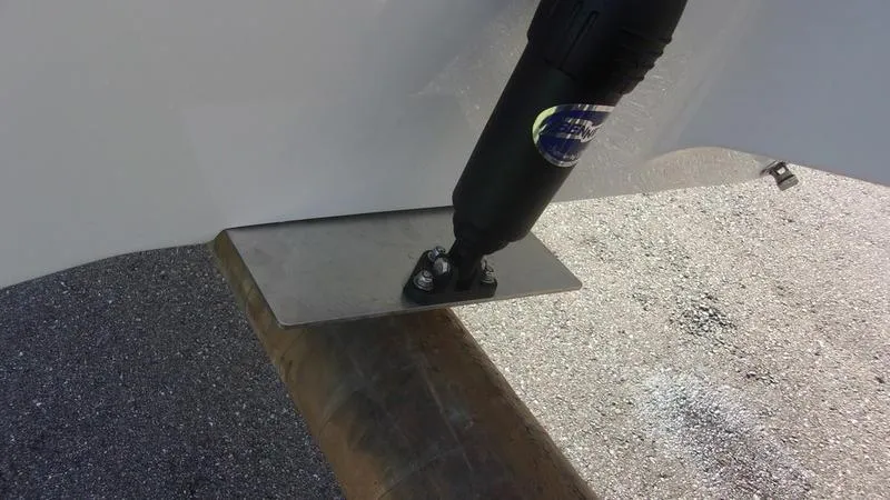 Slide: The Image of Trim tab on 2025 Key West 239 FS boat, close-up view. - 7