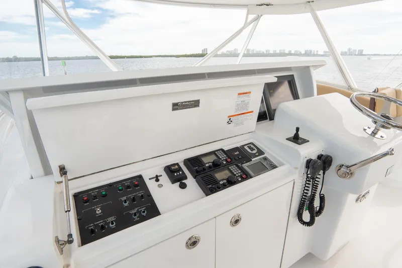 Slide: The Image of Hatteras GT60 2010 yacht helm with control panel and steering wheel. - 17