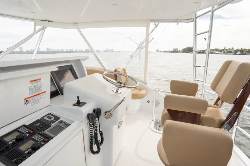 Slide: The Image of 2010 Hatteras GT60 yacht helm with beige seating and ocean view. - 18