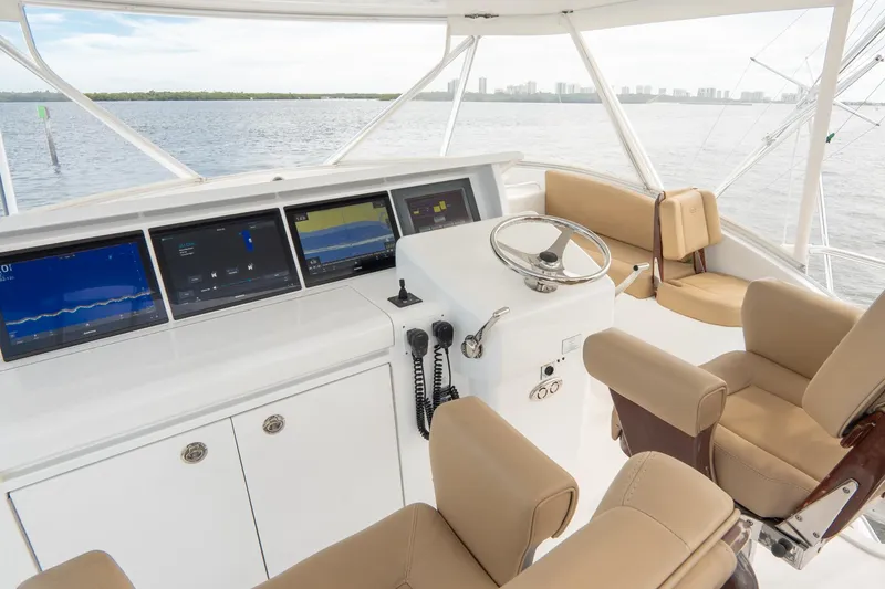 Slide: The Image of Luxurious 2010 Hatteras GT60 yacht helm with modern navigation displays and comfortable seating. - 19
