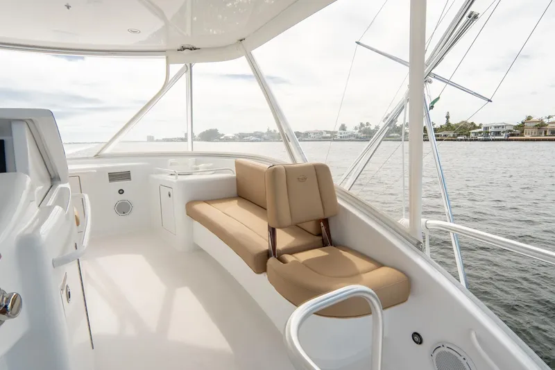 Slide: The Image of 2010 Hatteras GT60 yacht interior with beige seating and ocean view. - 21