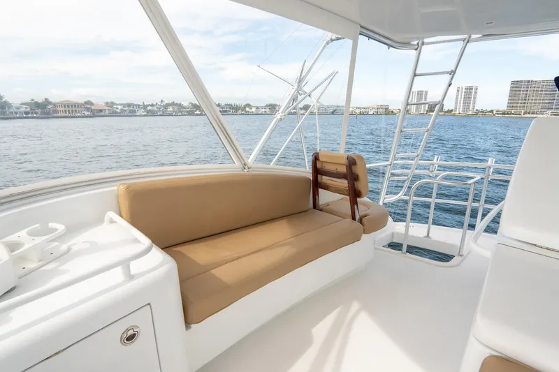 Slide: The Image of 2010 Hatteras GT60 yacht interior with beige seating and ocean view. - 22