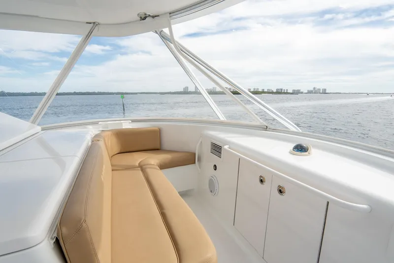 Slide: The Image of 2010 Hatteras GT60 yacht interior with tan seating, overlooking serene ocean view. - 23