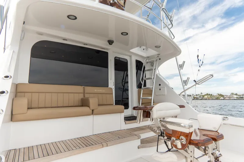 Slide: The Image of 2010 Hatteras GT60 yacht deck with seating and fishing equipment. - 25
