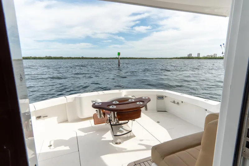 Slide: The Image of Hatteras GT60 2010 yacht deck overlooking calm waters and distant shoreline. - 28