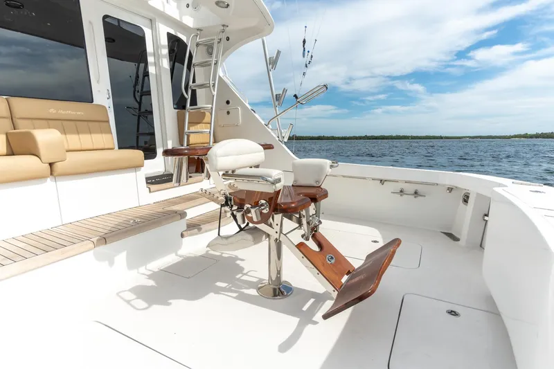 Slide: The Image of 2010 Hatteras GT60 yacht deck with fishing chair and ocean view. - 32