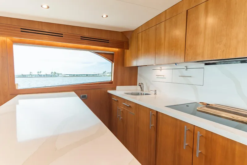 Slide: The Image of Luxurious kitchen interior of 2010 Hatteras GT60 yacht with wooden cabinets and ocean view. - 34