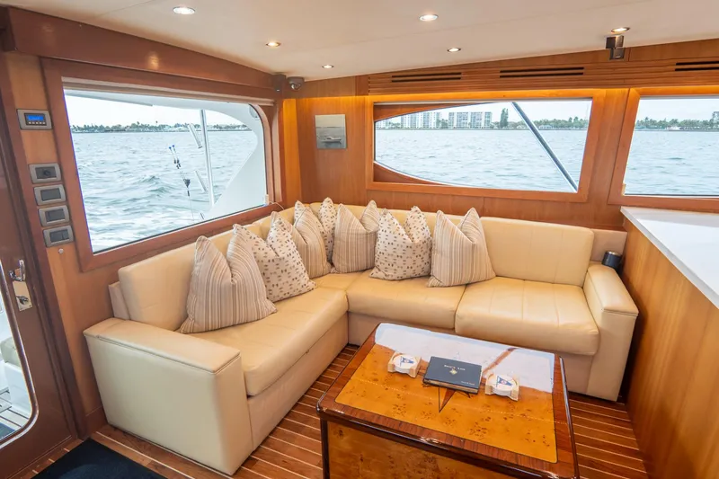 Slide: The Image of Luxurious interior of 2010 Hatteras GT60 yacht with plush seating and scenic window views. - 36