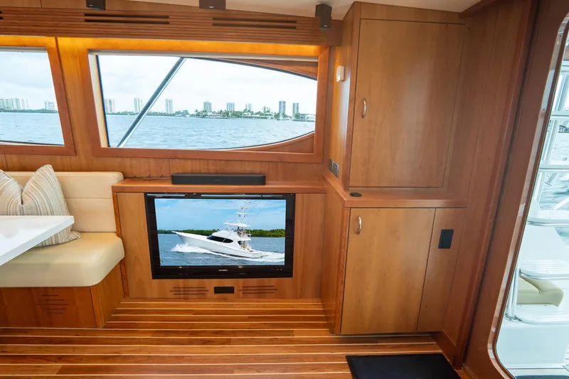 Slide: The Image of Luxurious 2010 Hatteras GT60 yacht interior with wood finish and scenic window view. - 37