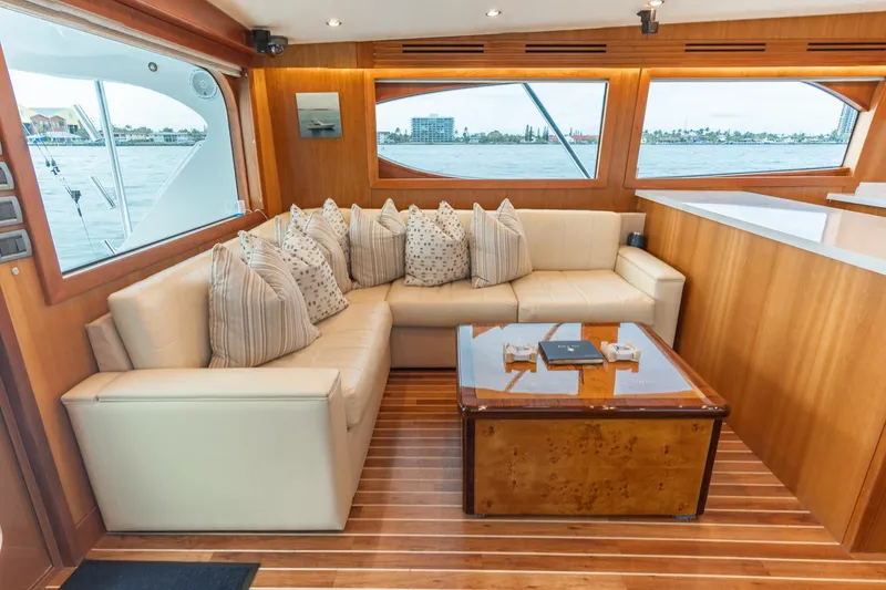 Slide: The Image of Luxurious 2010 Hatteras GT60 yacht interior with plush seating and elegant wood finishes. - 39