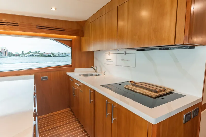 Slide: The Image of Luxurious 2010 Hatteras GT60 yacht kitchen with modern wood cabinetry and ocean view. - 41