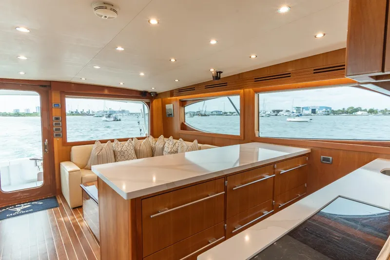 Slide: The Image of Luxurious 2010 Hatteras GT60 yacht interior with modern wood finishes and waterfront views. - 43
