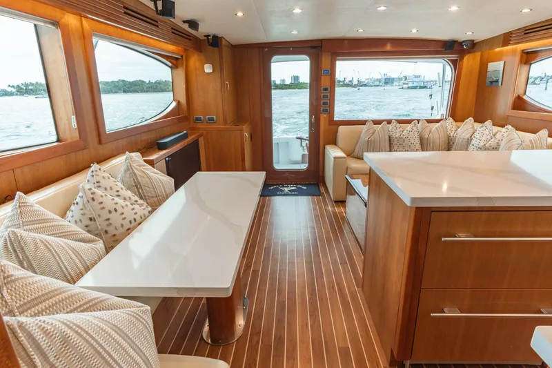 Slide: The Image of Luxurious 2010 Hatteras GT60 yacht interior with elegant wood finish and spacious seating. - 44