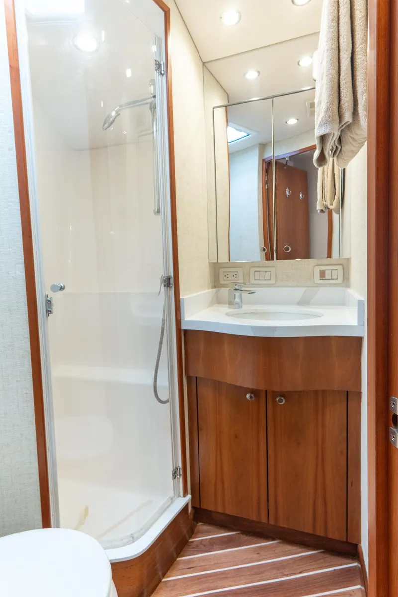 Slide: The Image of Luxurious bathroom in 2010 Hatteras GT60 yacht with modern shower and wooden cabinetry. - 48