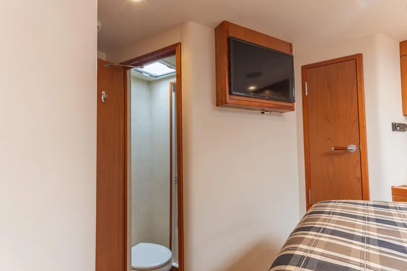 Slide: The Image of Interior of 2010 Hatteras GT60 yacht cabin with TV and bathroom. - 49