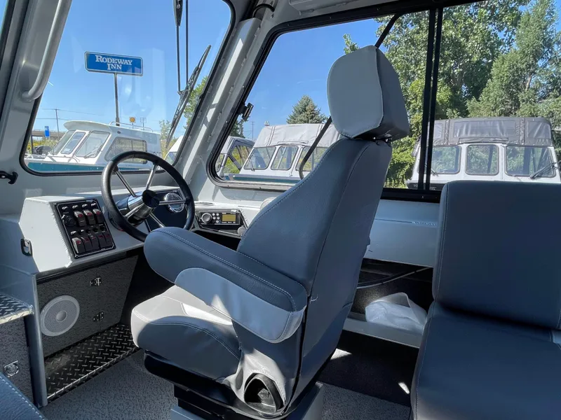 Slide: The Image of 2025 Hewescraft 210 Sea Runner ET HT interior with captain's chair and dashboard. - 13