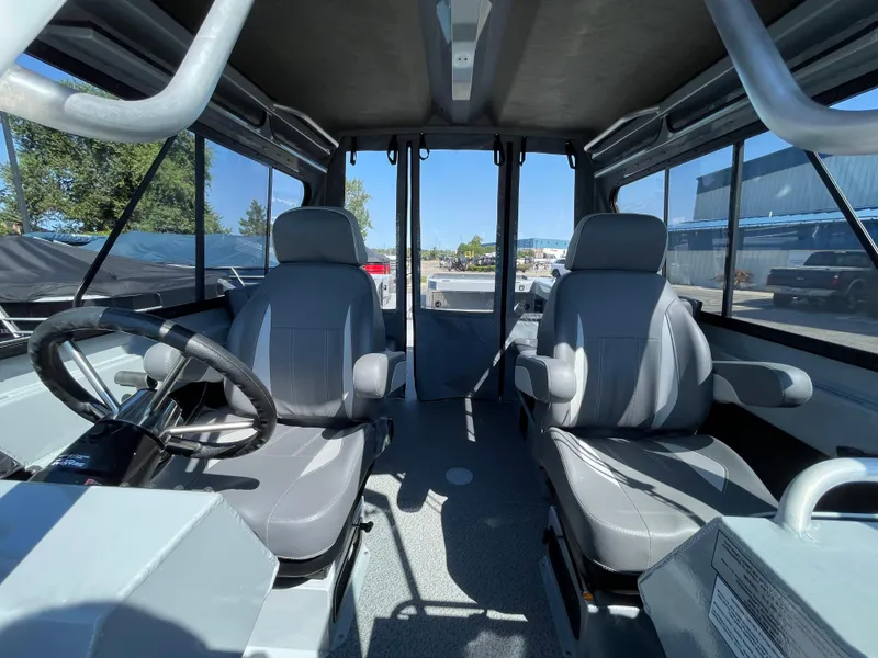 Slide: The Image of Interior of 2025 Hewescraft 210 Sea Runner ET HT boat, featuring dual seats and steering wheel. - 20
