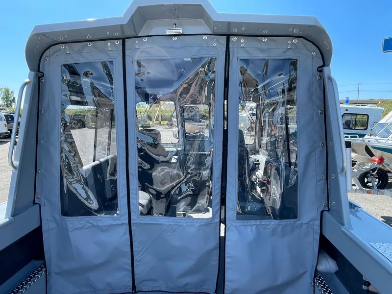 Slide: The Image of 2025 Hewescraft 210 Sea Runner ET HT boat with clear vinyl cabin enclosure. - 24