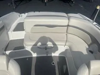 Slide: The Image of 2007 Chaparral 220 SSi boat interior with curved seating and shadow on deck. - 10