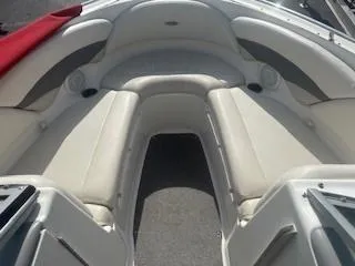 Slide: The Image of 2007 Chaparral 220 SSi boat interior with white seating and red cover. - 11