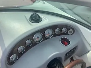 Slide: The Image of Dashboard of a 2007 Chaparral 220 SSi boat with gauges and compass. - 15