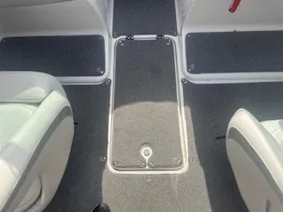 Slide: The Image of Interior view of 2007 Chaparral 220 SSi boat, featuring gray carpet and seating. - 16