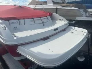 Slide: The Image of 2007 Chaparral 220 SSi boat with red cover, docked in a marina. - 3
