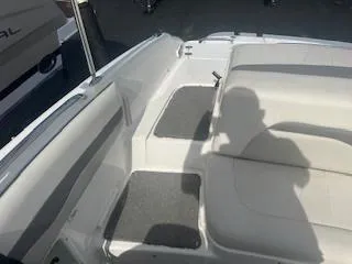 Slide: The Image of 2007 Chaparral 220 SSi boat interior with white seating and gray carpet. - 9