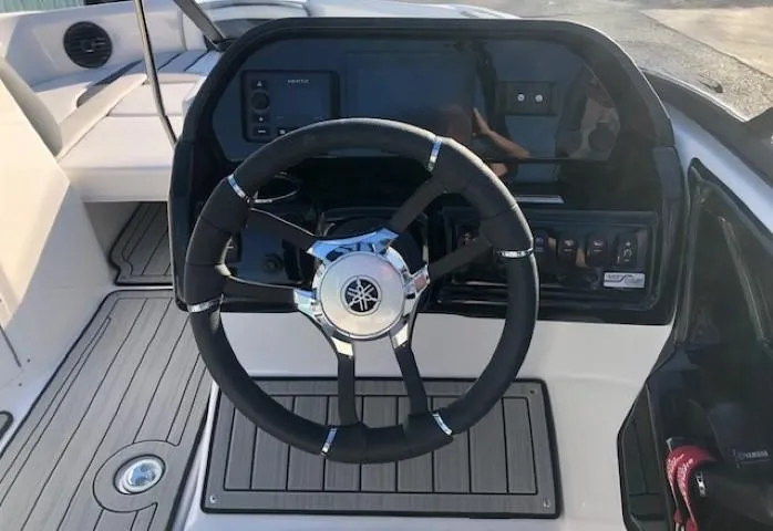 Slide: The Image of Steering wheel of 2025 Yamaha Boats 195S, featuring modern dashboard controls. - 12
