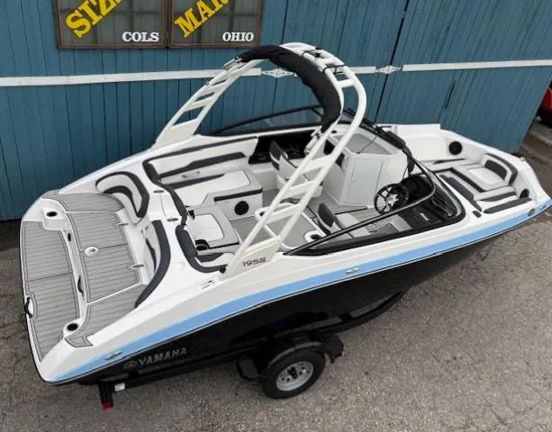 Slide: The Image of 2025 Yamaha Boats 195S, sleek design, black and white exterior, spacious interior, parked outdoors. - 6