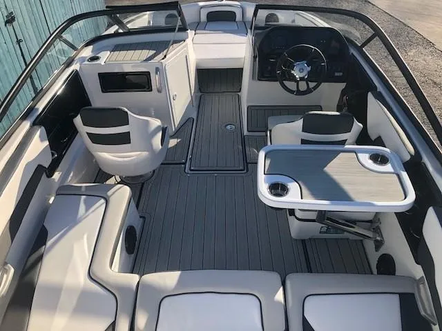 Slide: The Image of 2025 Yamaha Boats 195S interior with seating, steering wheel, and table. - 9