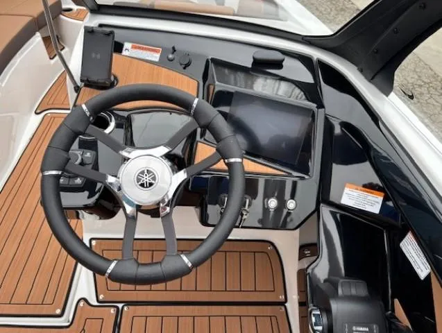 Slide: The Image of 2025 Yamaha Boats 222S dashboard with steering wheel and touchscreen display. - 10