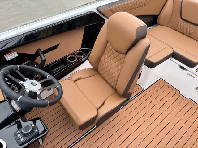 Slide: The Image of 2025 Yamaha Boats 222S interior with tan leather seats and modern steering console. - 11