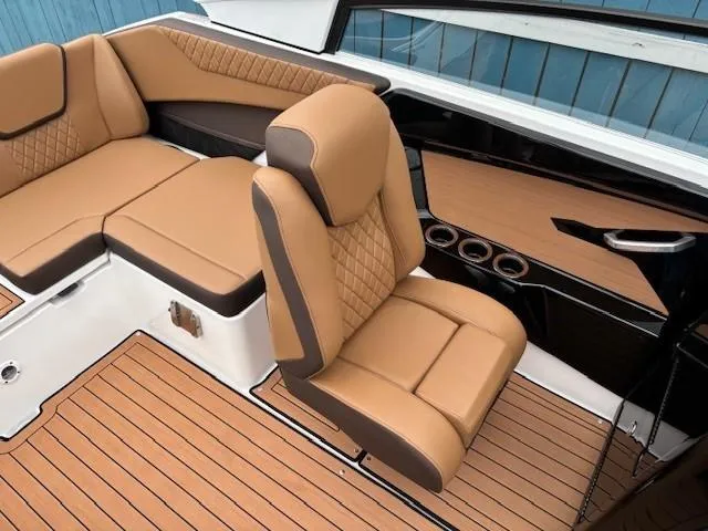 Slide: The Image of Luxurious interior of 2025 Yamaha Boats 222S with tan leather seating and wood-style flooring. - 13
