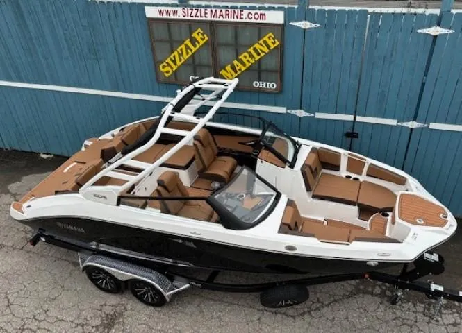 Slide: The Image of 2025 Yamaha Boats 222S, sleek design, brown seating, on trailer at Sizzle Marine. - 5