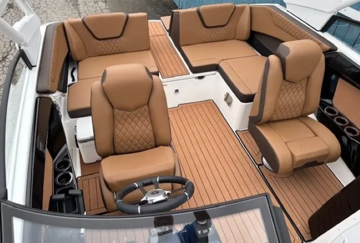 Slide: The Image of 2025 Yamaha Boats 222S interior with luxurious tan seating and sleek design. - 8