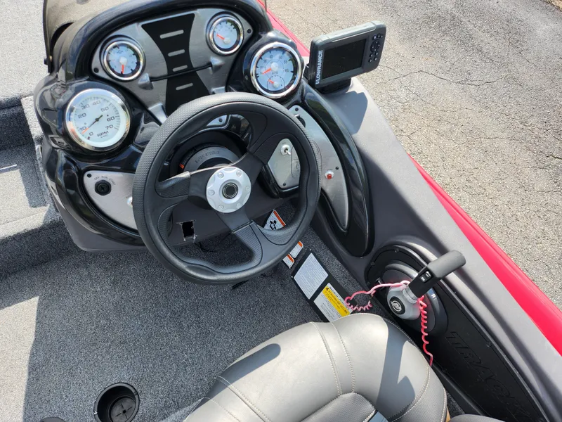 Slide: The Image of 2020 Tracker Pro Team 175 TXW boat dashboard with steering wheel and gauges. - 11