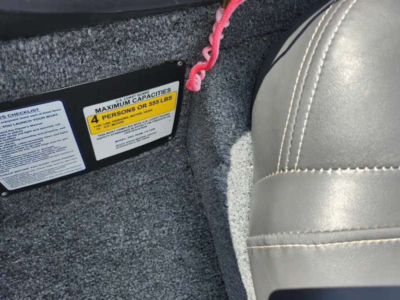 Slide: The Image of 2020 Tracker Pro Team 175 TXW boat interior with capacity label and seat detail. - 12