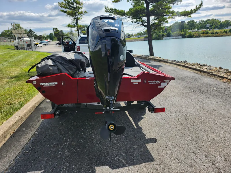 Slide: The Image of 2020 Tracker Pro Team 175 TXW boat on trailer by lakeside road. - 2