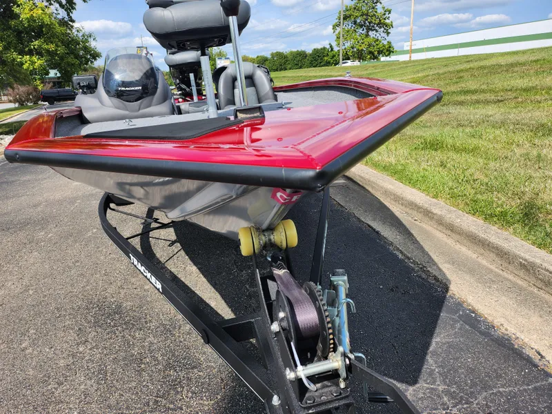 Slide: The Image of 2020 Tracker Pro Team 175 TXW boat on trailer, red and silver, parked on pavement. - 6
