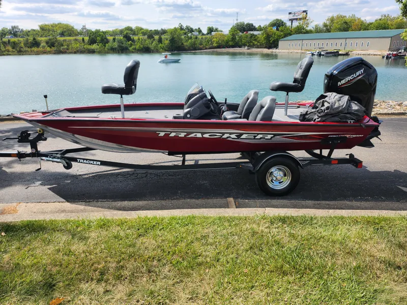 Slide: The Image of 2020 Tracker Pro Team 175 TXW boat on trailer by a lake. - 9