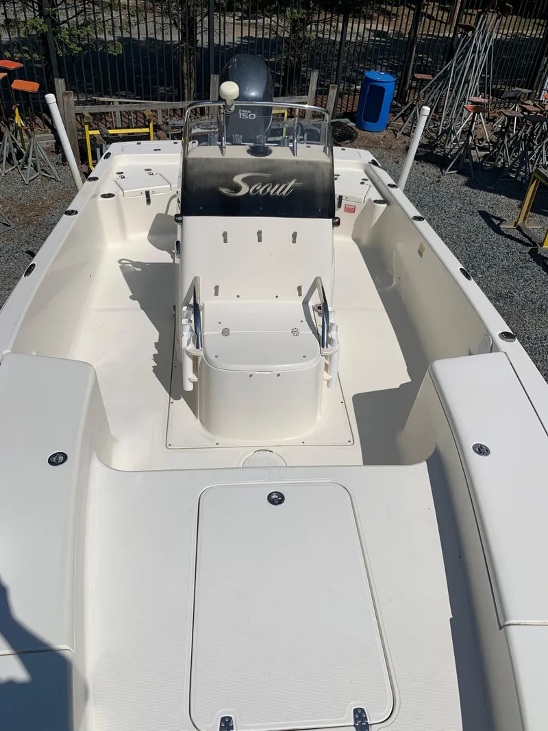 Slide: The Image of 2008 Scout 221 Winyah Bay boat interior, featuring a central console and seating. - 11