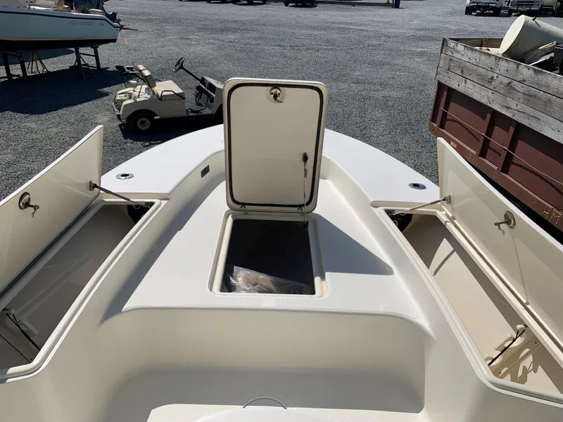 Slide: The Image of 2008 Scout 221 Winyah Bay boat with open storage compartments on deck. - 15