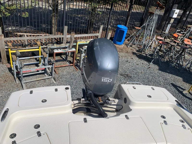 Slide: The Image of 2008 Scout 221 Winyah Bay boat with Yamaha 150 outboard motor, parked outdoors. - 19