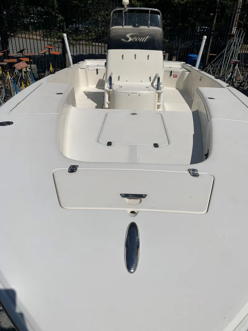 Slide: The Image of 2008 Scout 221 Winyah Bay boat, white deck, center console, outdoor setting. - 4