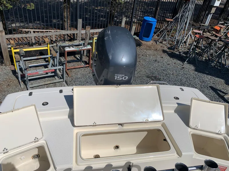 Slide: The Image of 2008 Scout 221 Winyah Bay boat with Yamaha 150 engine, open storage compartments. - 5