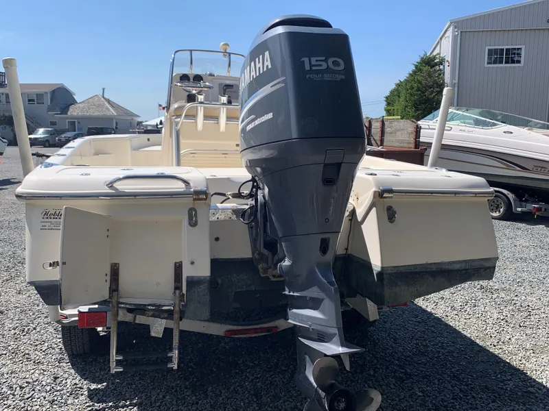Slide: The Image of 2008 Scout 221 Winyah Bay boat with Yamaha 150 engine, parked on gravel. - 7