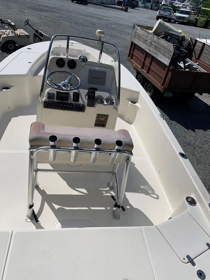 Slide: The Image of 2008 Scout 221 Winyah Bay boat interior with steering console and rod holders. - 8